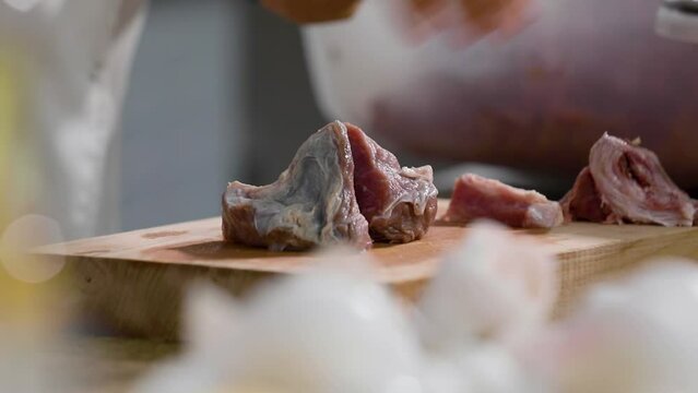Chef cuts beef meat