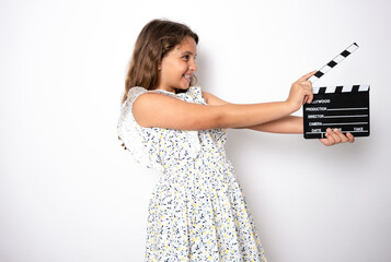 Beautiful young girl, holding a movie makers clapperboard. Isolated on studio white background.
