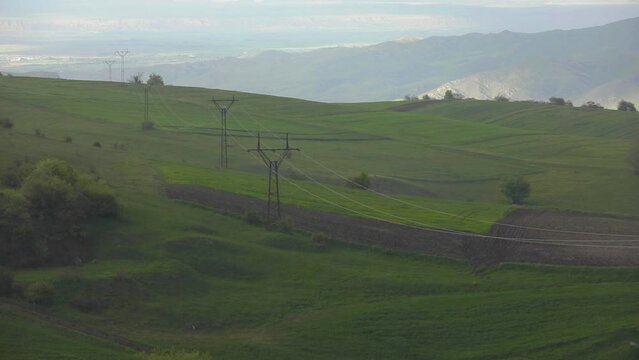 Enchanting landscape amidst torrential rain and electric pоles