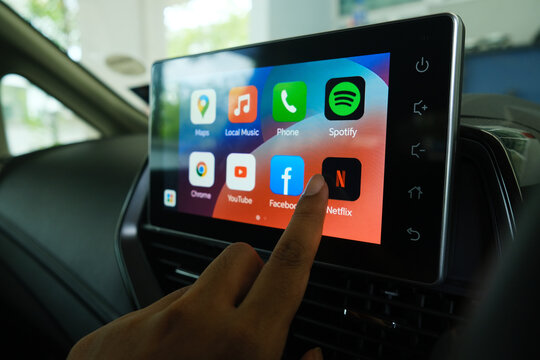 "Rimbayu, Malaysia- July 5, 2023: Selective focus with noise effect of finger choosing Netflix at car Android Infotainment Player used in B Segment Sedan car."