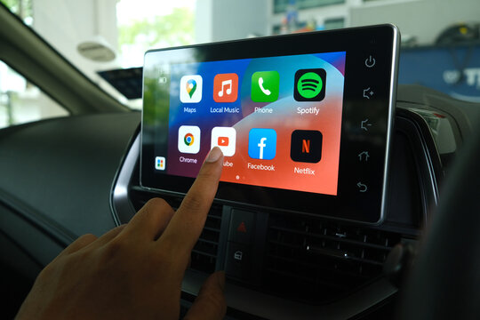 "Rimbayu, Malaysia- July 5, 2023: Selective focus with noise effect of finger choosing Youtube at car Android Infotainment Player used in B Segment Sedan car."