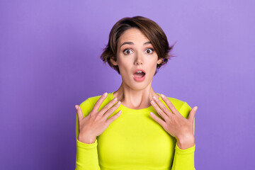 Photo of funny surprised girl wear trendy yellow shirt palms touch chest unexpected reaction confused isolated on violet color background
