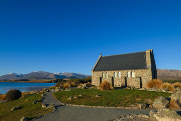 Fototapeta na wymiar The Church of the Good Shepherd late in the afternoon on a sunny day in Lake Tekapo, New Zealand