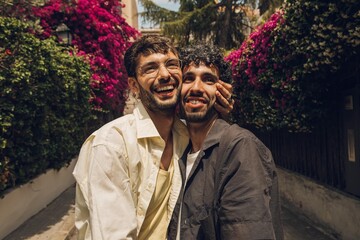 couple of men looking at something with happiness