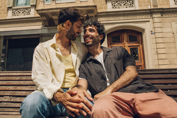 Fototapeta premium Happy gay couple kissing in the park. LGBT gay couple concept.