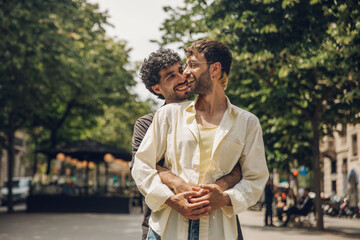 couple walking kissing and huging in the city