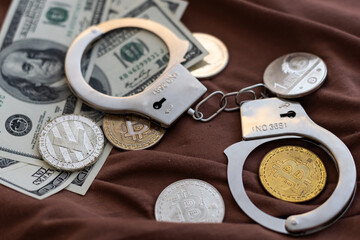 Fototapeta na wymiar Bitcoins and handcuffs as an abstract symbol of crime that can hide a crypto currency.