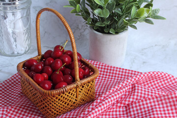 An antique basket of freshly picked cherries