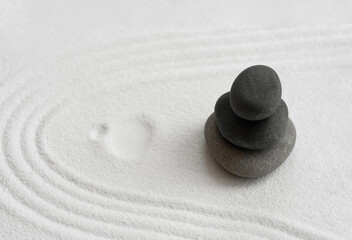 Zen Garden with Stack stone on white Sand line pattern in Japanese stye, Rock Sea Stone on Sand texture with the wave parallel lines,Spa Therapy,Purity harmony and Balance ,Meditation,Zen like concept