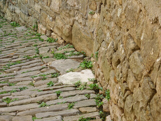 Stone-paved street along the fortified city wall in the old town