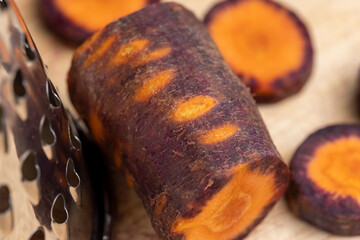 Pieces of sliced peeled carrots are red-orange in color
