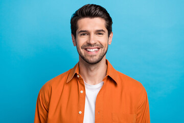Portrait of positive friendly man beaming smile good mood nice hairstyle isolated on blue color...