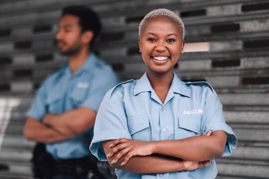 Portrait, security or law enforcement and a happy black woman arms crossed with a man colleague on the street. Safety, smile and duty with a crime prevention unity working as a team in an urban city