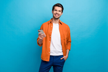 Portrait of positive nice person toothy smile hold use apple iphone texting chatting isolated on...