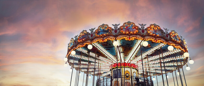 Part of popular vintage carousel (merry-go-round) by the Eiffel Tower in Paris on  sky sunset background. France. Copy space. Empty space for message.