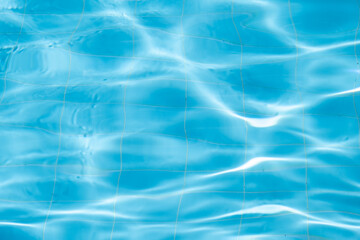 Water background, ripple and flow with waves. Summer blue swiming pool pattern. Sea, ocean surface. Overhead top view with place for text.