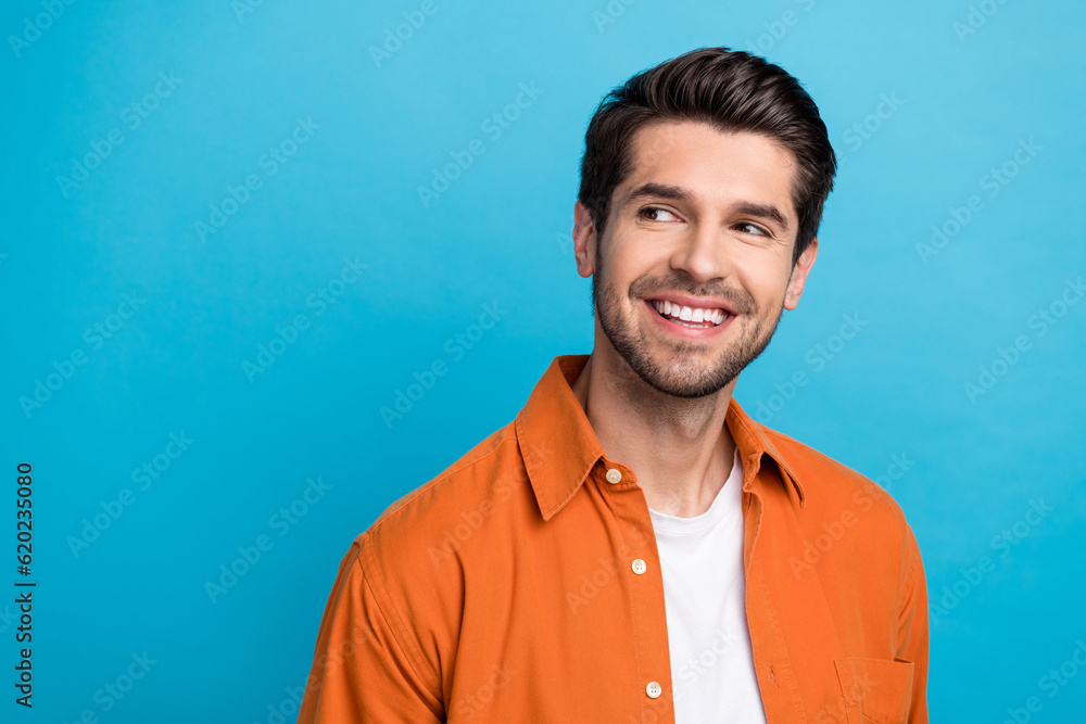 Poster portrait of minded creative positive nice man beaming smile look empty space advert isolated on blue