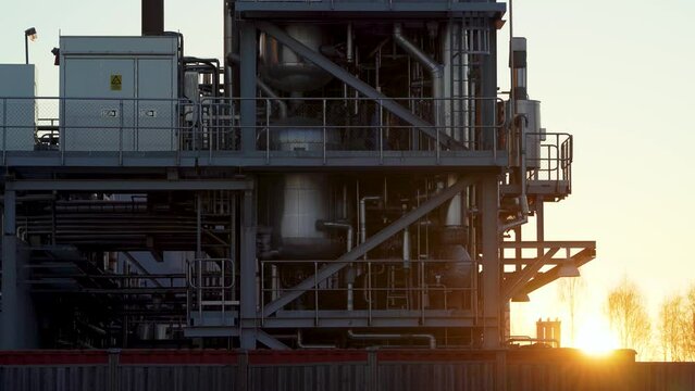 Industrial Pipelines details up close during sunset at paper mill factory in Northern Sweden.