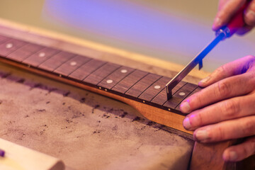 Unstrung Guitar Fretboard and Tiny Refret Saw with Blue Light Leak, Refretting, Wood Shop,...