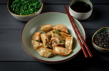 japanese fried gyoza dumplings, with pork, sesame seeds, green onions,