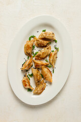 japanese fried gyoza dumplings, with pork, sesame seeds, green onions,