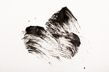 Black mascara brush strokes isolated on white.