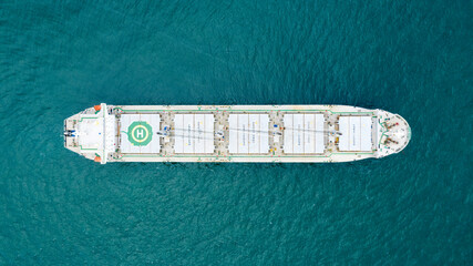 Self-unloading bulk carrier at Rio De La Plata anchorage. Aerial top down view.