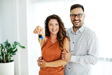 young couple new house keys buy real estate home agent agreement investment apartment owner property