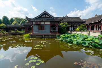 Naklejka premium Chinese ancient architecture, garden scenery, and ponds full of lotus flowers