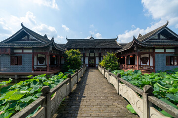 Fototapeta na wymiar Chinese ancient architecture, garden scenery, and ponds full of lotus flowers