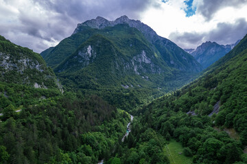 Fototapeta na wymiar Alpine landscape with green forest in Predil Pass, Italy. Aerial drone view