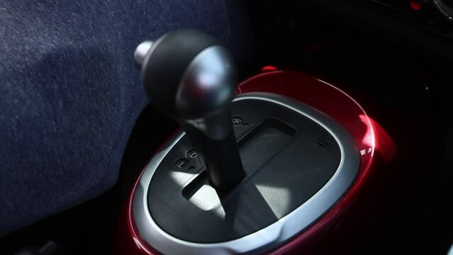 man's hand shifting gears automatic transmission car 