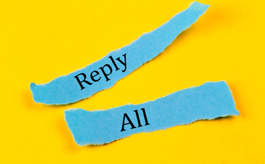 REPLY ALL text on a blue pieces of paper on yellow background, business concept