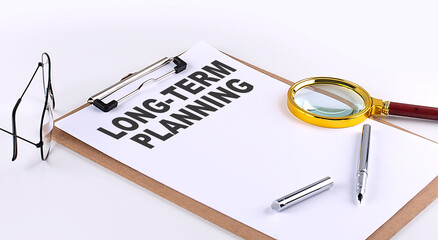 LONG TERM PLANNING text on clipboard on white background, business concept