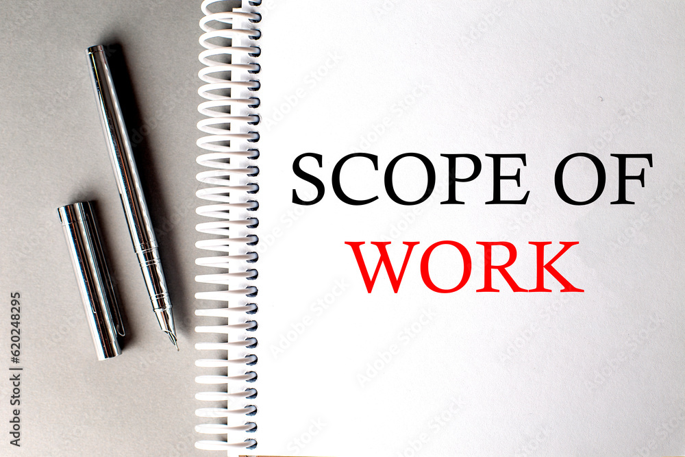 Poster scope of work text on a notebook with pen on grey background