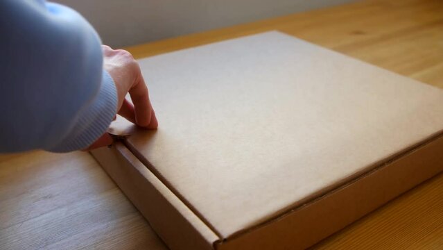 view side - woman hands open delivery box with pizza, delivery concept. 4k slow motion. flatley - female opening box with pizza. appetizing fresh cooked italian pizza with sausage in delivery box on