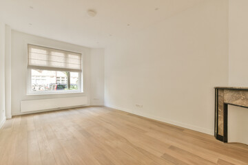 Fototapeta na wymiar an empty living room with wood flooring and white walls, there is a fire place in the corner window