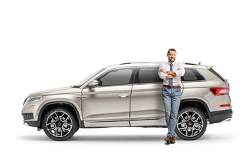 Full length portrait of a man leaning on a SUV