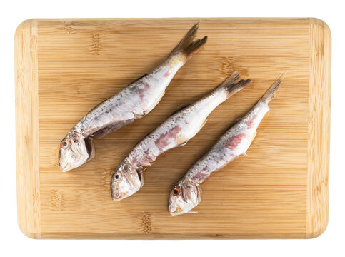 raw cleaned red mullet on a board