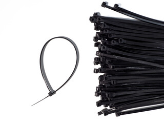 Plastic black ties on a white background. Plastic ties for cables.