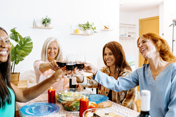 Group of Friends Enjoying a Festive Home Gathering with Wine and Food
