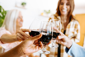 Group of Friends Enjoying a Festive Home Gathering with Wine and Food