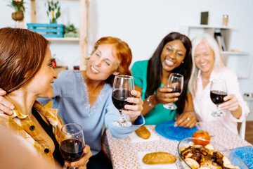 Group of Friends Enjoying a Festive Home Gathering with Wine and Food