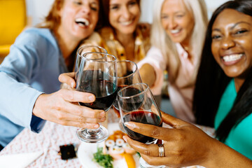 Group of Friends Enjoying a Festive Home Gathering with Wine and Food