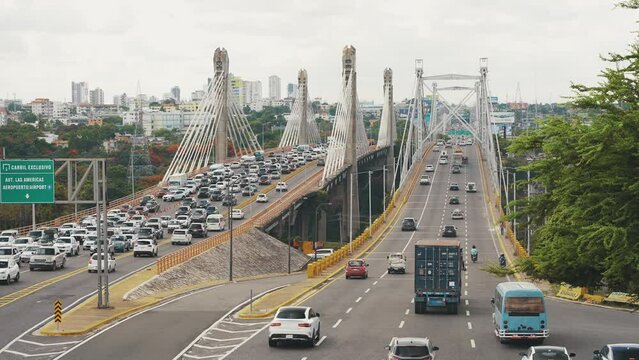 Cars and trucks at rush hour in Santo Domingo este on Juan Bosch Bridge.