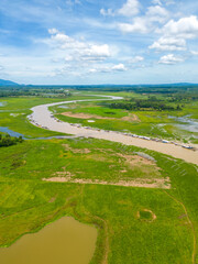 Naklejka premium Aerial view of National Route 20 in Dong Nai province, group of floating house on La Nga river, Vietnam with hilly landscape and sparse population around the roads.