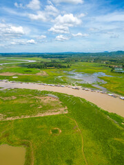 Fototapeta na wymiar Aerial view of National Route 20 in Dong Nai province, group of floating house on La Nga river, Vietnam with hilly landscape and sparse population around the roads.