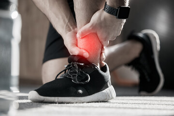 Hand, ankle pain and injury with the leg of a man in red highlight during a fitness workout....