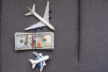 Toy plane and money on background. Travel insurance