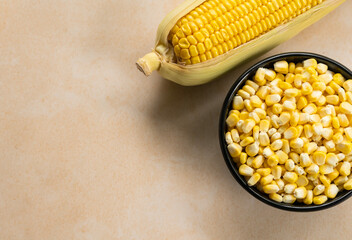 Top view of fresh con seeds on a black bowl with copy space